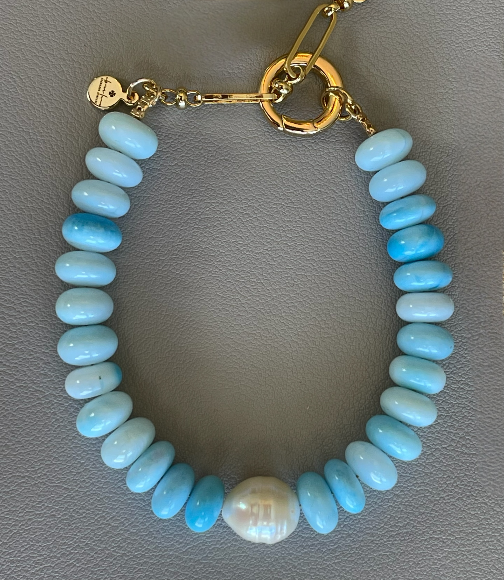 Robin’s Egg Opal Bracelet: Robin’s egg blue Opals with a Baroque Pearl center Gold clasp