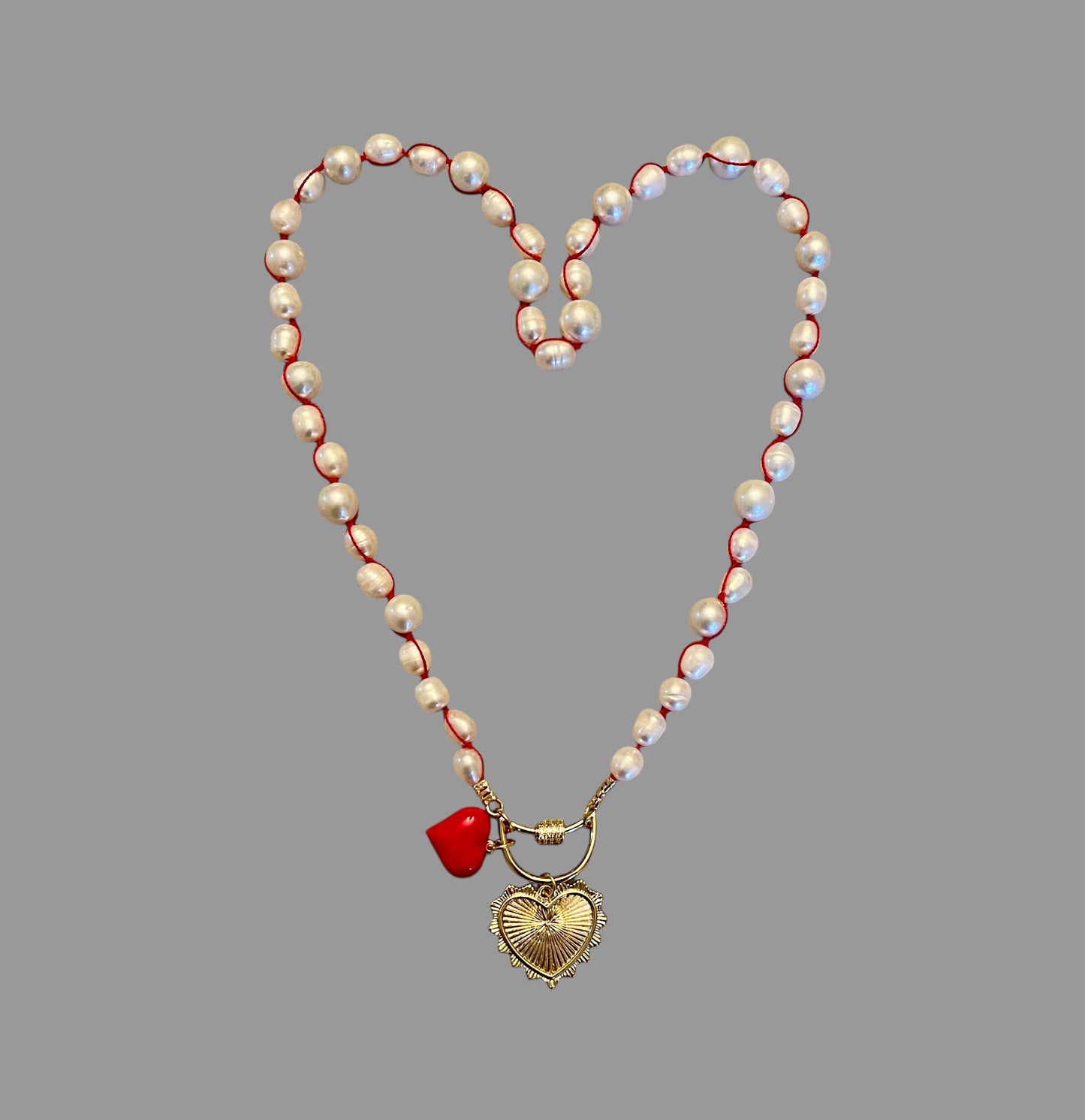 The Heartstrings Necklace: Luminous high quality freshwater pearls hand knotted on red silk w/ gold and red enameled heart charms, pavé accented clasp/charm holder OOAK
