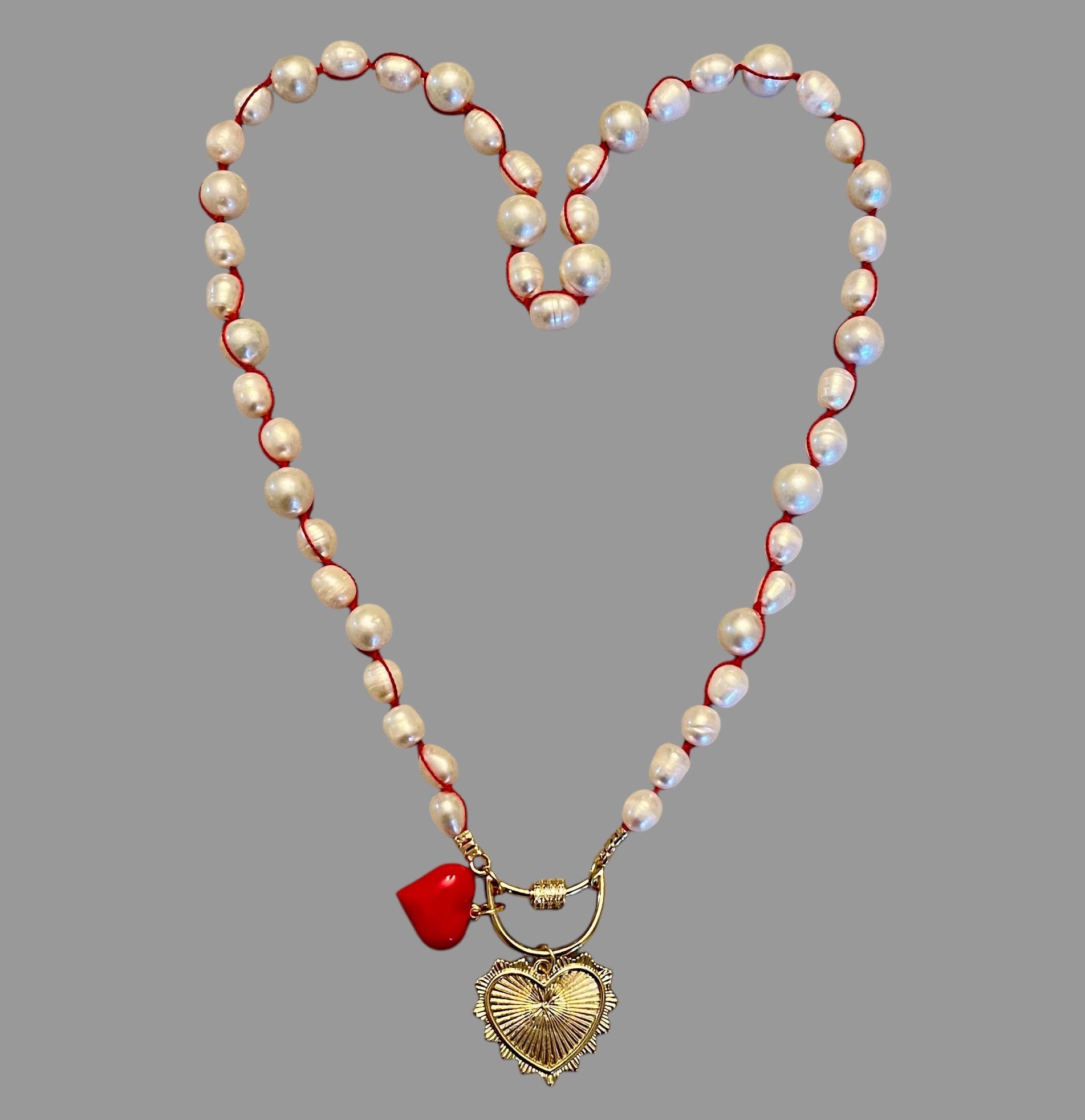 The Heartstrings Necklace: Luminous high quality freshwater pearls hand knotted on red silk w/ gold and red enameled heart charms, pavé accented clasp/charm holder OOAK