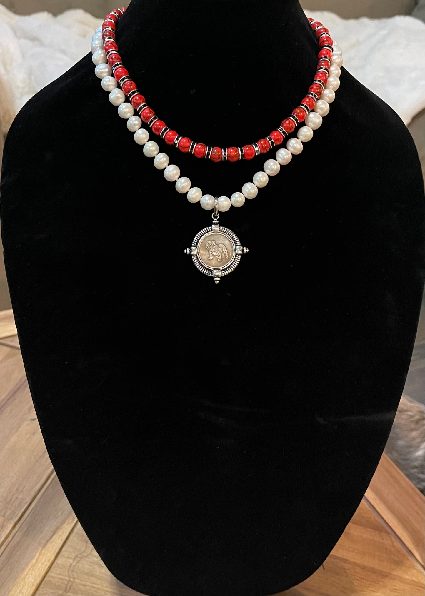 Go Dawgs Necklace: Hand-knotted Freshwater Pearls layered with Red & black marbled beads accented by black sparkling spacer beads and a chic coin-style Bulldog pendant Pinch clasp