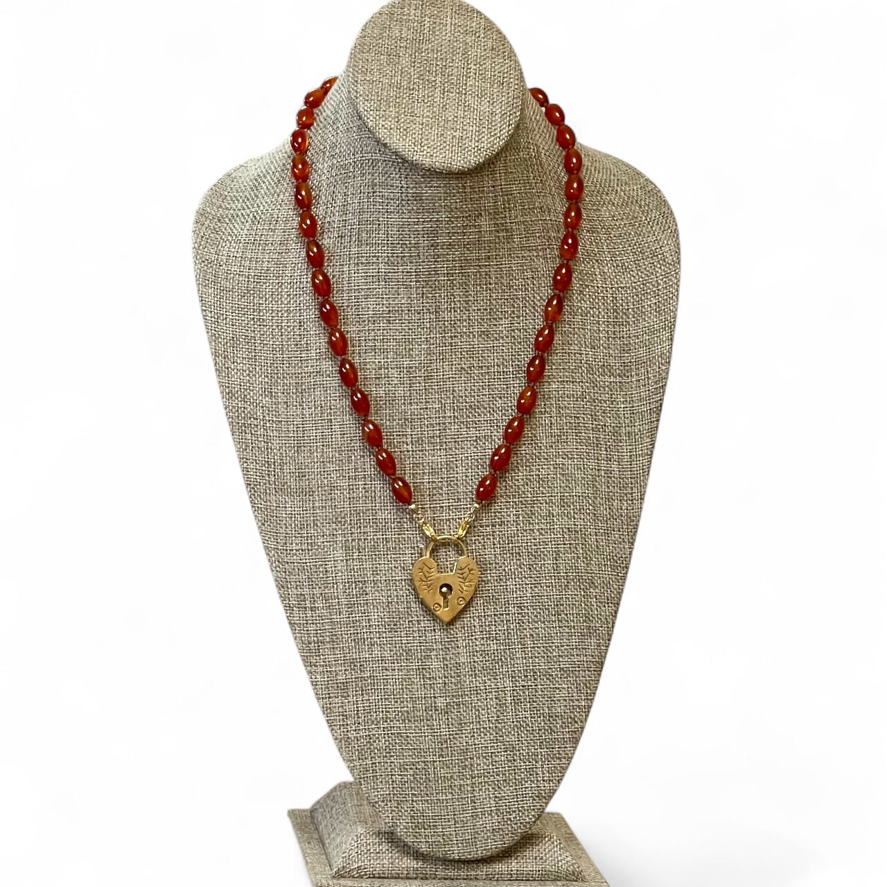 Carnelian Heartlock Necklace: Carnelian gemstone oval beads handknotted on warm brown silk GF heart pendant