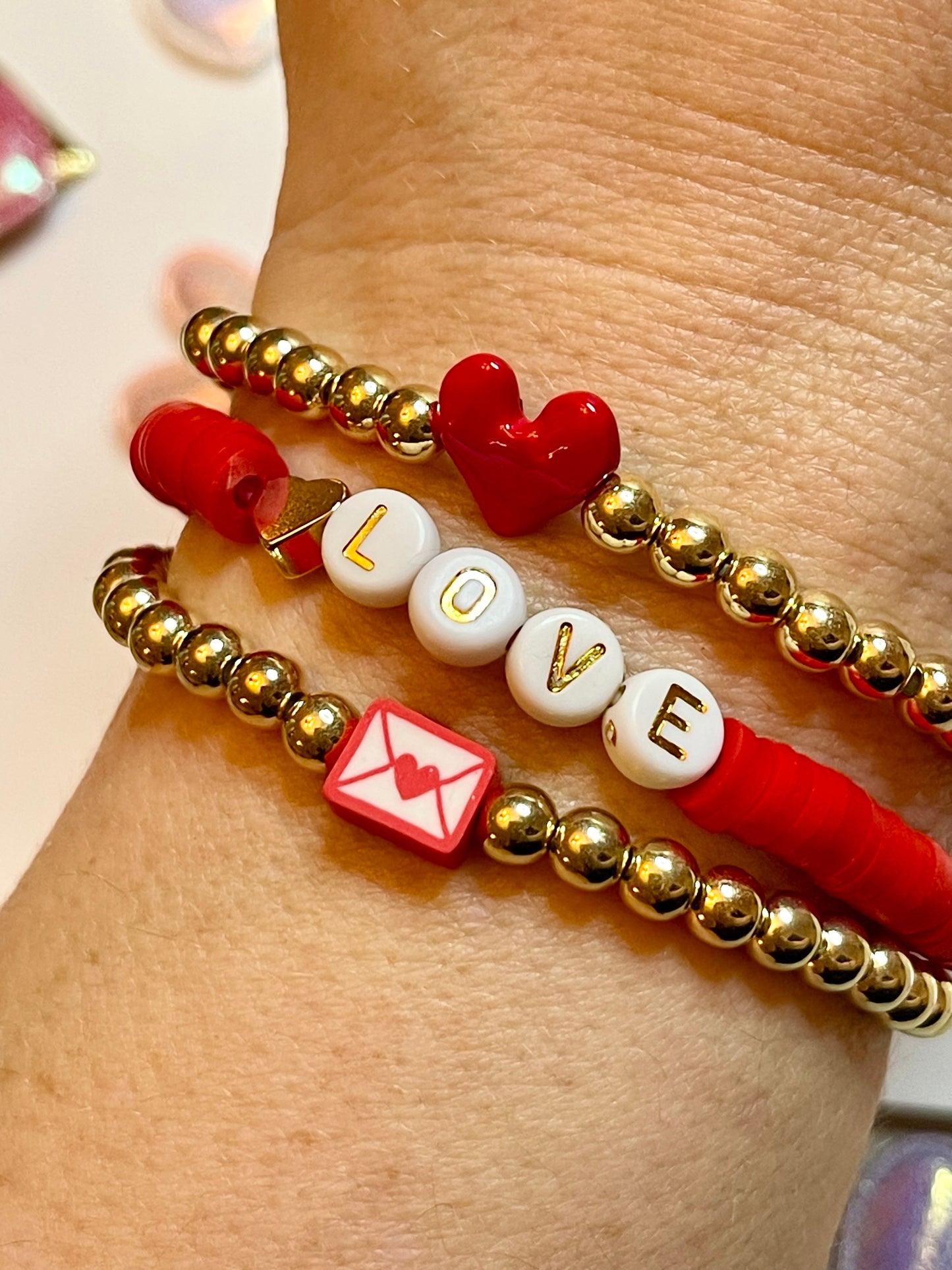 Love Stack 4: OOAK! Two gold plated bead bracelets with center charm and a red clay bracelet with letter beads