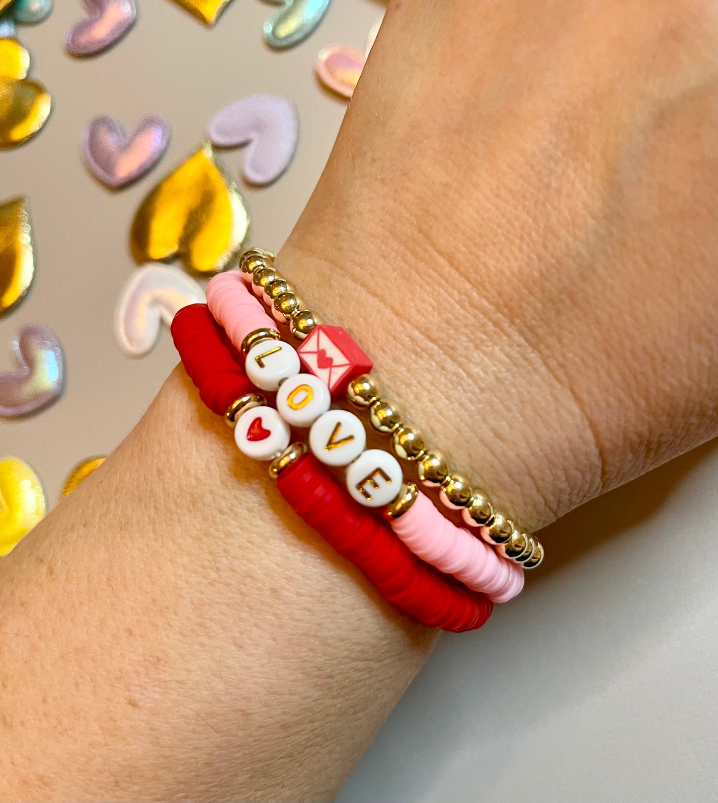 Love Stack 1: Red&Pink clay bead bracelets with acrylic letter beads and a gold plated bead bracelet featuring a love letter charm