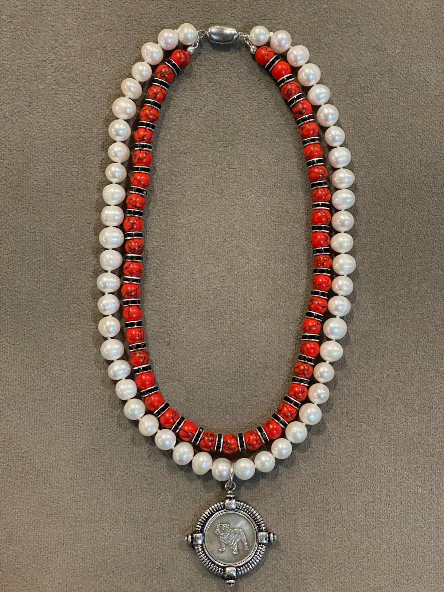 Go Dawgs Necklace: Hand-knotted Freshwater Pearls layered with Red & black marbled beads accented by black sparkling spacer beads and a chic coin-style Bulldog pendant Pinch clasp