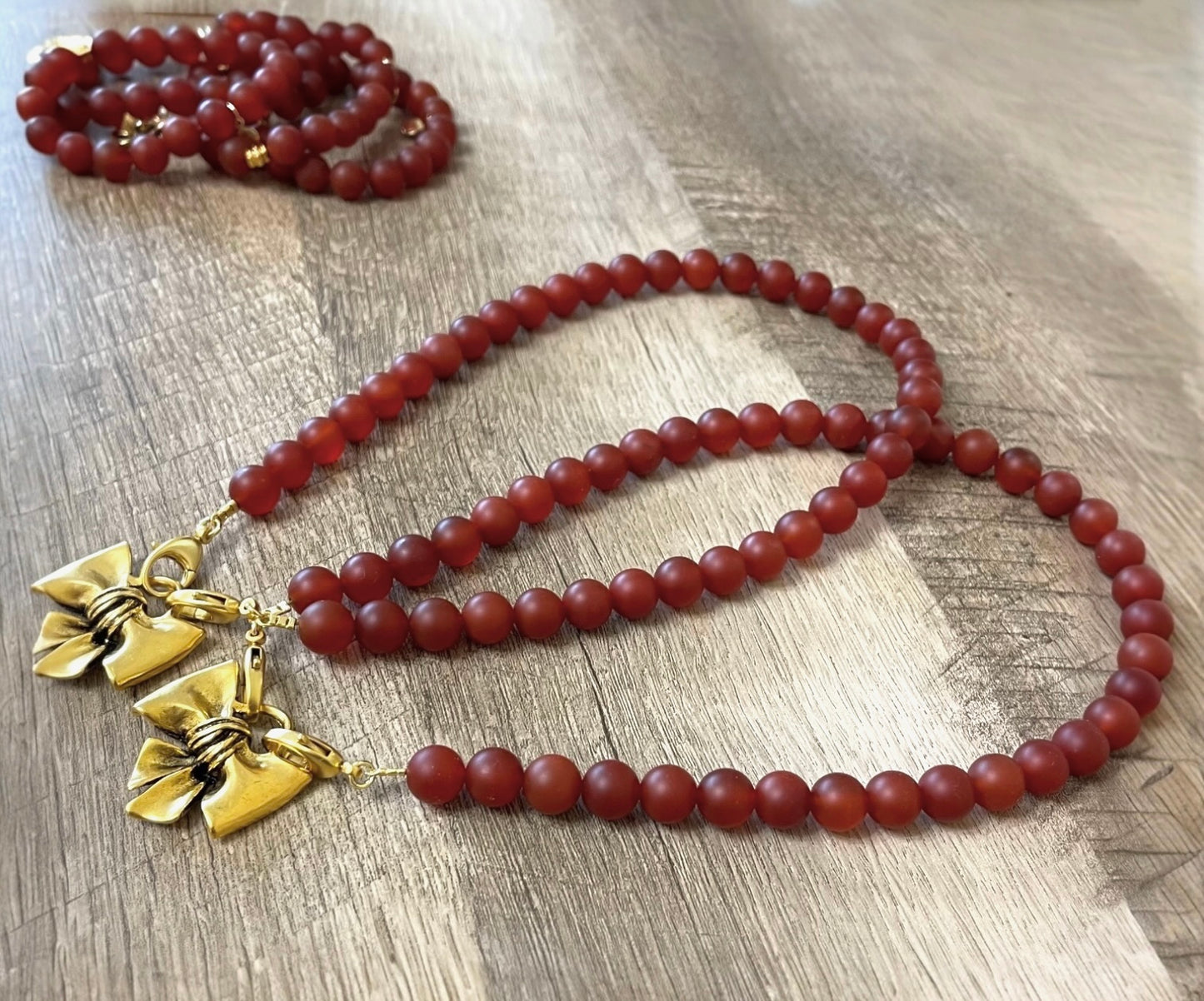 Matte Carnelian Bow Necklace: Matte Carnelian gemstone beads Antiqued gold bow pendant
