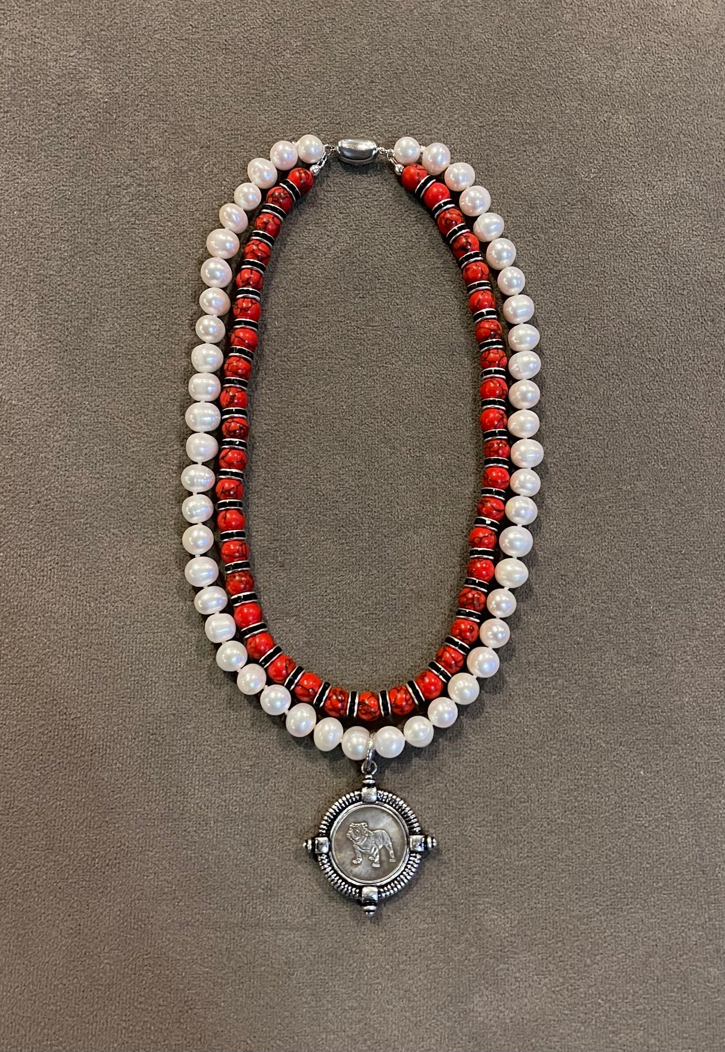 Go Dawgs Necklace: Hand-knotted Freshwater Pearls layered with Red & black marbled beads accented by black sparkling spacer beads and a chic coin-style Bulldog pendant Pinch clasp