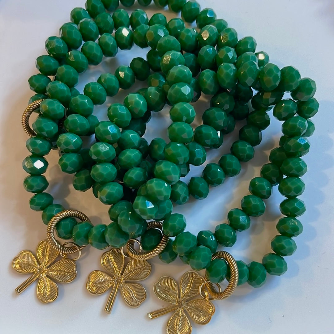 Lucky Charm Bracelet: Gorgeous tone of green in a faceted acrylic beaded stretch bracelet with a solid brass charm