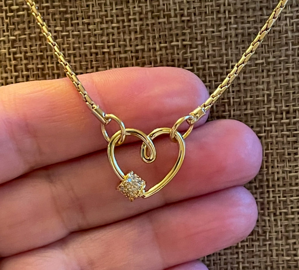 Be Still My Heart Necklace: A thin gold cable chain w/ an adorable heart that doubles as a clasp and a charm holder Pavé screw closure OOAK