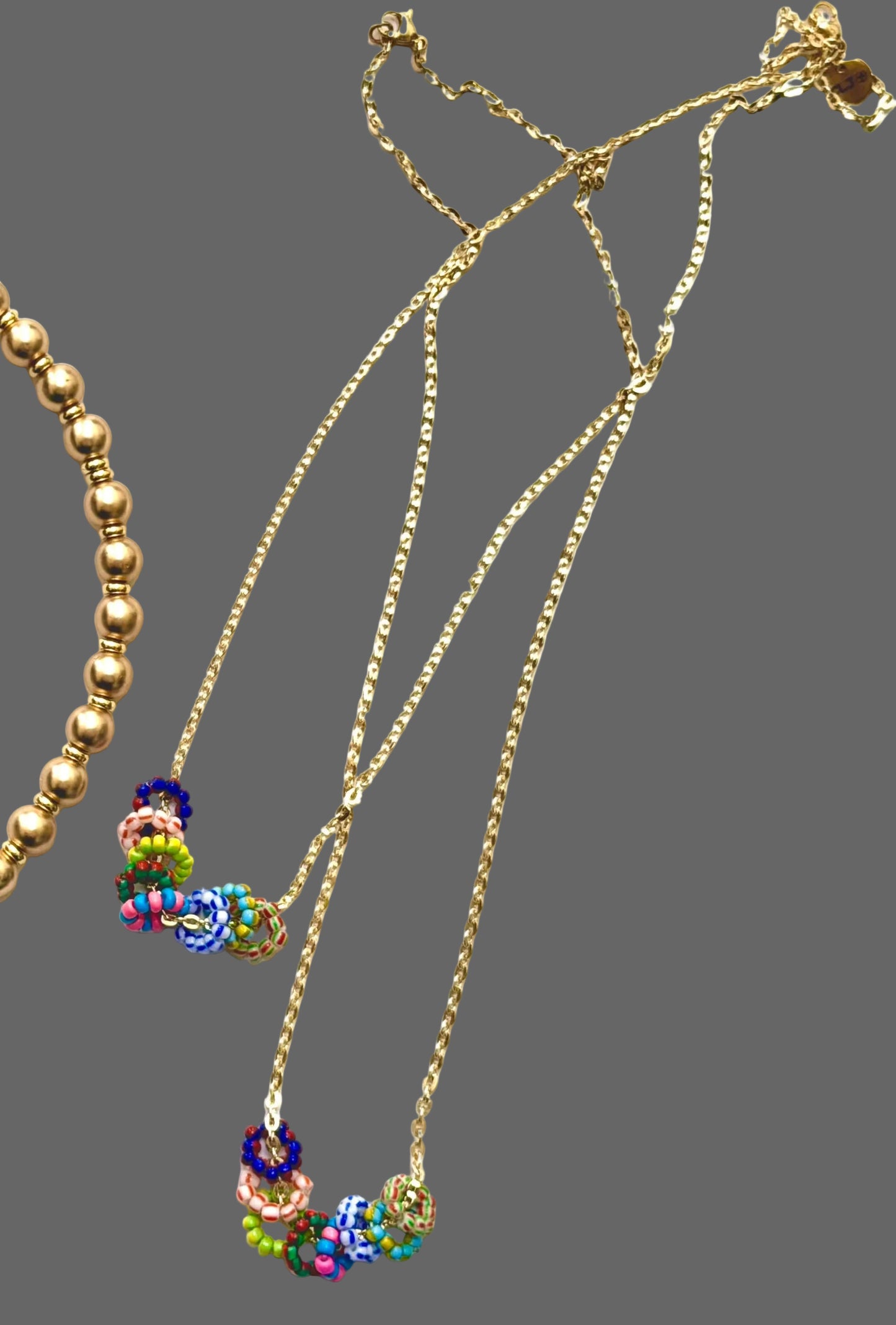 The Inner Circle Necklace: A Gold Filled diamond cut cable chain w/ mini glass bead circle charms